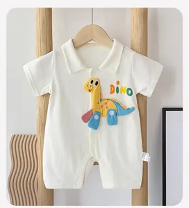 Detail of white cotton baby romper featuring a cute yellow dinosaur patch and dino embroidery
