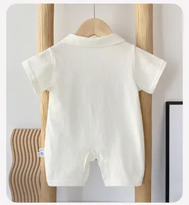Detail showing the 66cm size label and soft cotton fabric texture of the baby romper