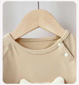 Detail of baby romper shoulder with white snap buttons and soft cotton knit fabric