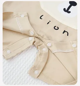 Detail of snap button closures and soft cotton fabric on lion baby bodysuit