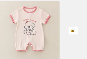Detail of pink cotton baby romper featuring a cute cream puppy print and snap buttons