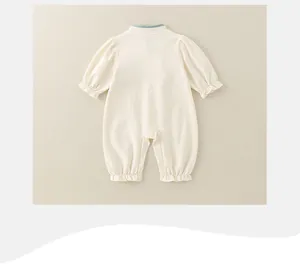 Detail view of the soft knit baby romper back with elastic ruffled cuffs and hemline