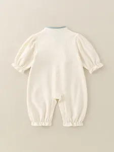Infant cream cotton bodysuit with blue collar trim and ruffled sleeves in back view