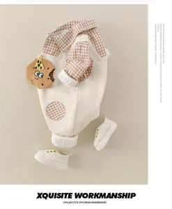 Baby boy autumn set with brown plaid shirt and cream overalls featuring biscuit embroidery