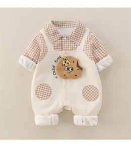 Detail of baby cotton romper featuring plaid patches and cute cake time embroidery