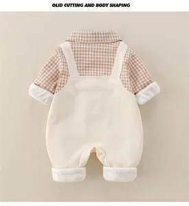 Detail of baby boy cotton outfit featuring a plaid shirt and ivory overall suspender pants