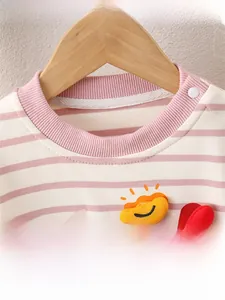 Close-up of pink striped baby cotton top with ribbed neckline and sun patch