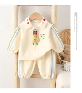 Detail of baby cream tracksuit featuring colorful 3D rainbow caterpillar and polo collar