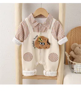 Detail of baby boy cotton romper with brown plaid shirt and cookie embroidery
