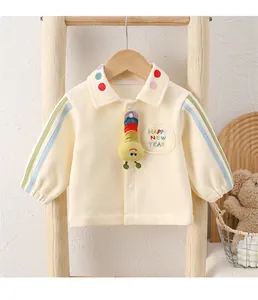 Detail of baby polo sweatshirt featuring 3D caterpillar charm and festive embroidery