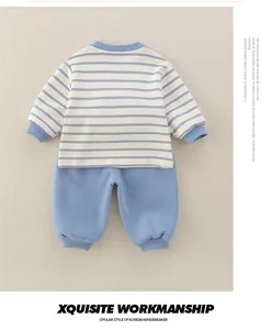 Detail of baby striped cotton sweatshirt and trousers set with ribbed cuffs and blue accents