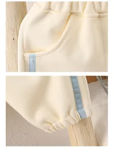 Detail of baby joggers showing elastic waistband and blue striped ribbed leg cuffs