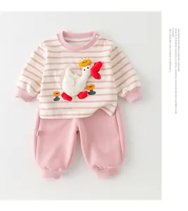 Detailed view of pink striped cotton baby set featuring a 3D duck patch and ribbed cuffs