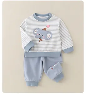 Detail of baby boy striped cotton set with cute elephant embroidery and shoulder snaps