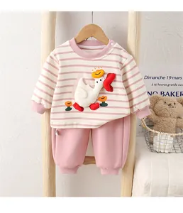 Detail of baby cotton striped sweatshirt and pink pants set with white goose embroidery