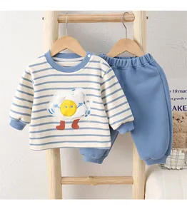 Detail of baby cotton striped long sleeve set with cute sun patch on wooden ladder