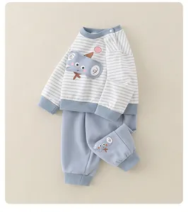 Detail of blue striped baby tracksuit with 3D elephant applique and ribbed cuffs