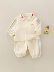 Childrens beige polo sweatshirt set with colorful embroidery and matching striped pants