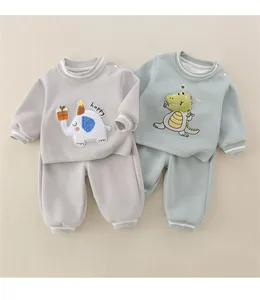 Detail of infant cotton outfits featuring 3D cartoon appliques and rib-knit cuffs