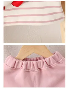 Detail of baby cotton outfit showing elastic waistband and striped hem with 3D decor