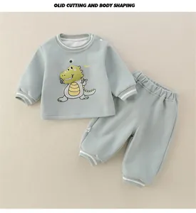 Detailed view of mint green baby set with 3D dinosaur patch and ribbed striped cuffs