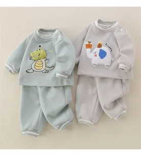 Detail of baby cotton dinosaur and elephant sweatshirt sets with ribbed cuffs
