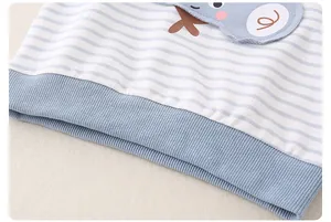 Detail of blue striped cotton sweatshirt with cute cartoon embroidery and ribbed hem