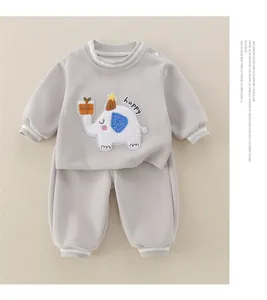 Detail of baby grey tracksuit featuring 3D cartoon elephant embroidery and ribbed cuffs