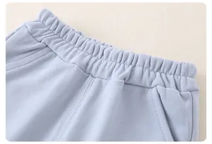 Detail of baby pants elastic waistband with pockets in light blue striped cotton fabric