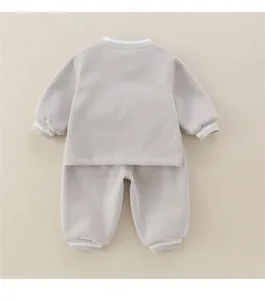 Detail of soft cotton baby tracksuit showing ribbed cuffs with white stripe pattern