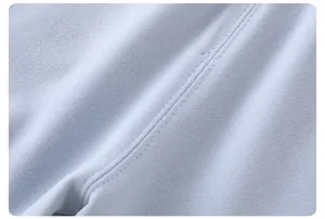 Macro shot of light blue striped knit cotton fabric showing fine texture and neat stitching