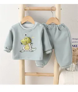 Detail of baby dinosaur track suit showing soft fabric and 3D plush dinosaur design
