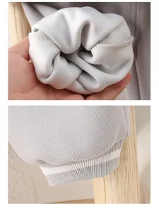Detail view of baby knit joggers with warm fleece lining and striped ribbed cuffs