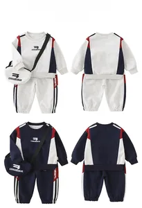 Detail view of cotton toddler tracksuit featuring sweatshirt, pants, and matching mini bag
