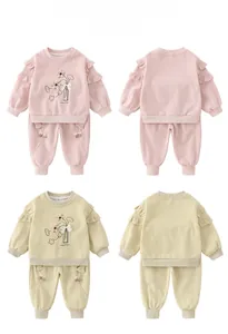 Detail of baby girl cotton sweatshirt set with ruffle shoulders and floral embroidery