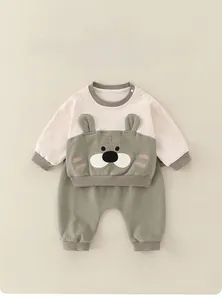 Detail of baby cotton two-piece set featuring 3D ear tiger embroidery and soft knit fabric