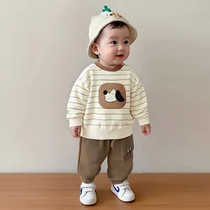 Detailed view of baby boy cotton set featuring striped sweatshirt and khaki pants