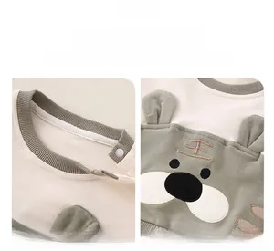 Detail of baby cotton jumpsuit with 3D tiger ears and snap-button neck for easy dressing