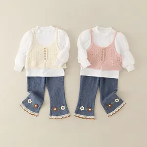 Detail of girls' floral embroidered flare jeans and lace trim for infant clothing set