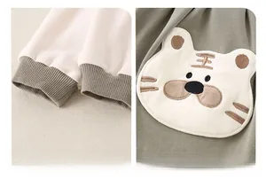 Detail of ribbed cuffs and 3D cartoon tiger patch on cotton baby romper for infants