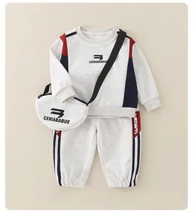 Detailed view of kids cotton tracksuit with grey sweatshirt, joggers, and small bag