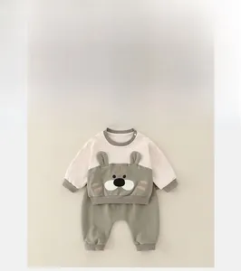 Flat lay of baby cotton two-piece set with tiger embroidery and ribbed cuffs