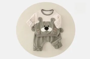 Detail of baby cotton two-piece set featuring cute animal pattern and 3D ears
