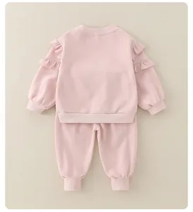 Detailed back view of pink baby girl cotton set with ruffled shoulders and ribbed cuffs
