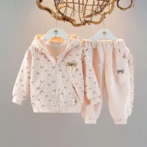 Detailed view of pink toddler girls' cotton set with bow prints and ruffle pants