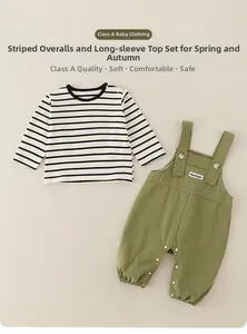 Detail of infant striped t-shirt and green overalls with convenient crotch snap buttons