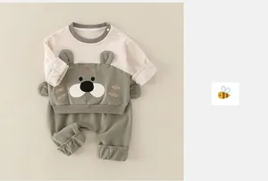 Detail of baby cotton tracksuit showing tiger applique and soft knit fabric texture