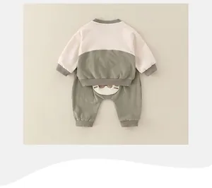 Detail of baby cotton tracksuit set featuring a cute cartoon bear patch on the back