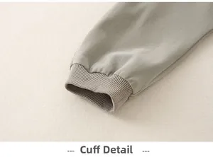 Macro shot of ribbed elastic cuffs on sage green cotton baby romper for soft fit