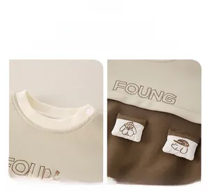 Detail view of cotton baby sweatshirt showing ribbed neckline and cartoon dog pockets